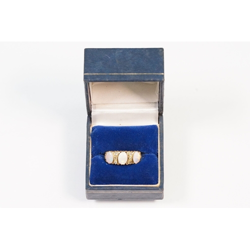 24 - 18ct gold, opal and diamond ring. The ring being set with three oval opal cabochons with six diamond... 