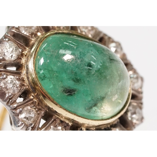 8 - Victorian emerald and diamond ring. The ring being set with a large oval green emerald cabochon, sur... 