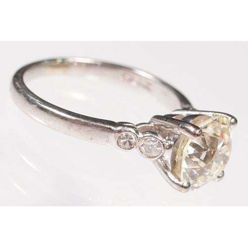 49 - Platinum and diamond ring. The ring being set with a round old cut diamond, flanked by four further ... 
