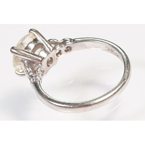 49 - Platinum and diamond ring. The ring being set with a round old cut diamond, flanked by four further ... 