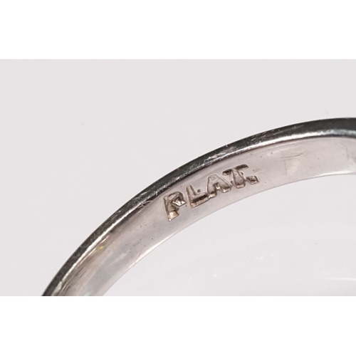 49 - Platinum and diamond ring. The ring being set with a round old cut diamond, flanked by four further ... 