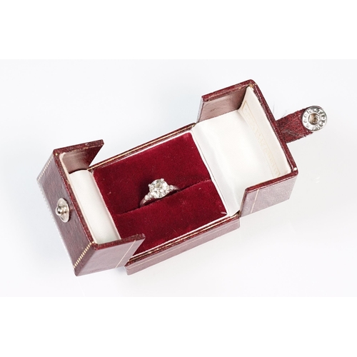 49 - Platinum and diamond ring. The ring being set with a round old cut diamond, flanked by four further ... 