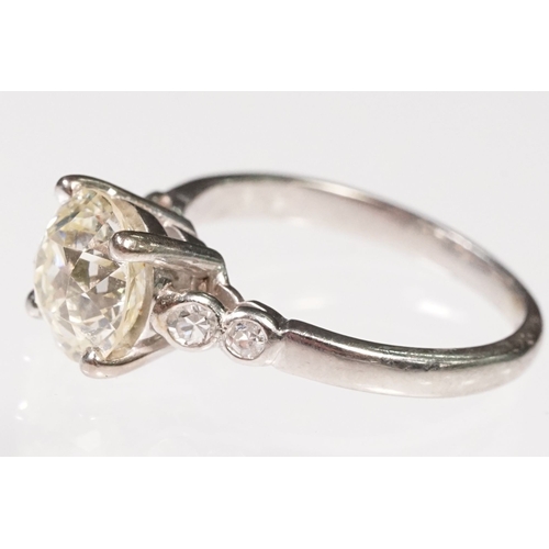 49 - Platinum and diamond ring. The ring being set with a round old cut diamond, flanked by four further ... 