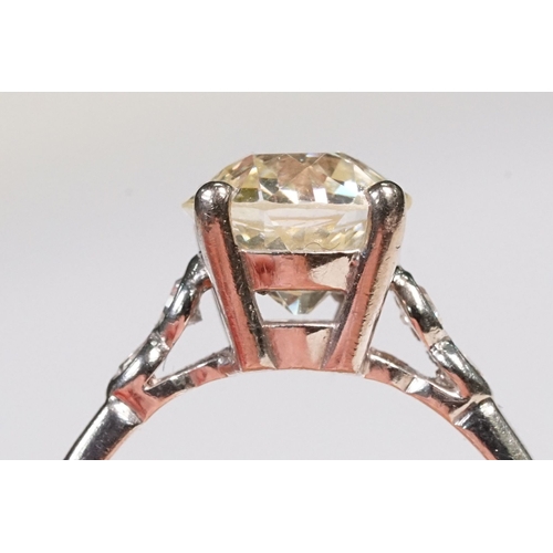 49 - Platinum and diamond ring. The ring being set with a round old cut diamond, flanked by four further ... 