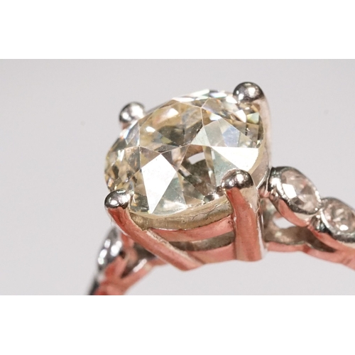 49 - Platinum and diamond ring. The ring being set with a round old cut diamond, flanked by four further ... 