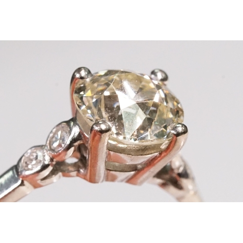 49 - Platinum and diamond ring. The ring being set with a round old cut diamond, flanked by four further ... 
