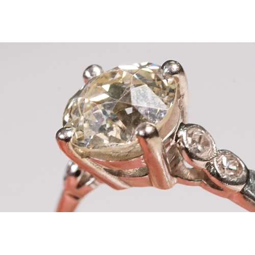 49 - Platinum and diamond ring. The ring being set with a round old cut diamond, flanked by four further ... 