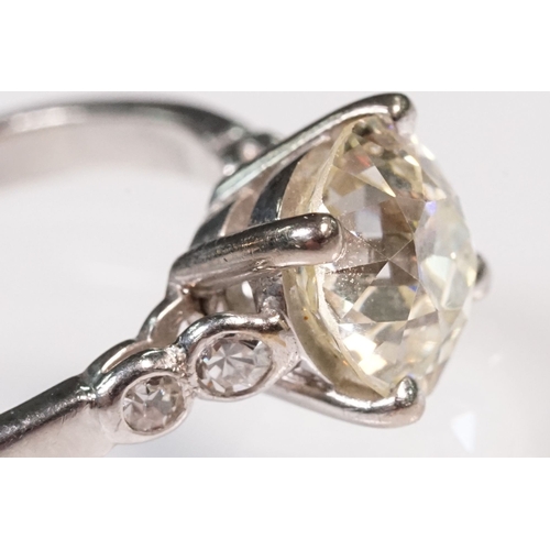 49 - Platinum and diamond ring. The ring being set with a round old cut diamond, flanked by four further ... 