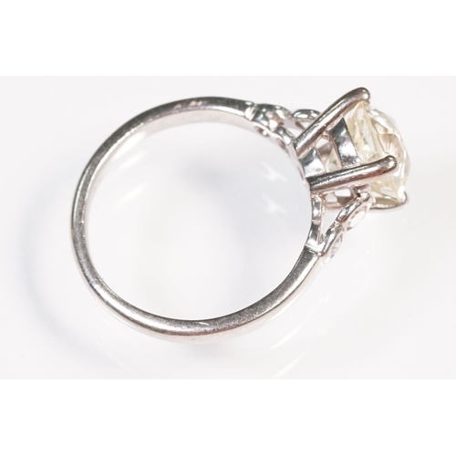 49 - Platinum and diamond ring. The ring being set with a round old cut diamond, flanked by four further ... 