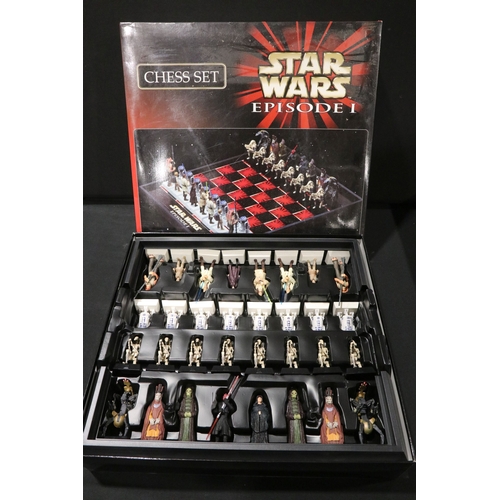 62 - Four boxed TV related chess sets to include DC Super Heroes, The Simpsons 'Antiqued metal style', St... 