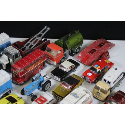 311 - Over 30 mid 20th C play worn diecast & plastic models to include Dinky, Corgi, Lonestar etc