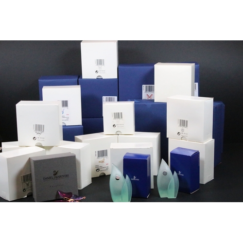 81 - Twenty-five boxed Swarovski crystal glass ornaments, to include a selection of 925 Sterling Silver g... 