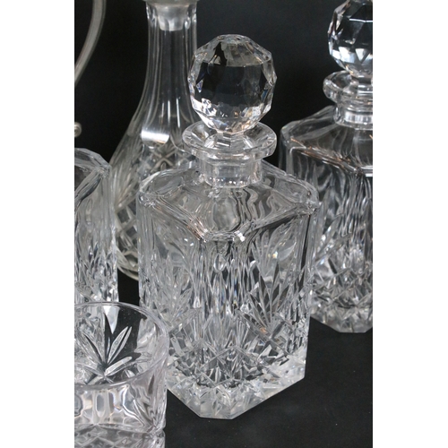 84 - Group of cut and moulded glass, to comprise primarily decanters, three of facetted square form, two ... 