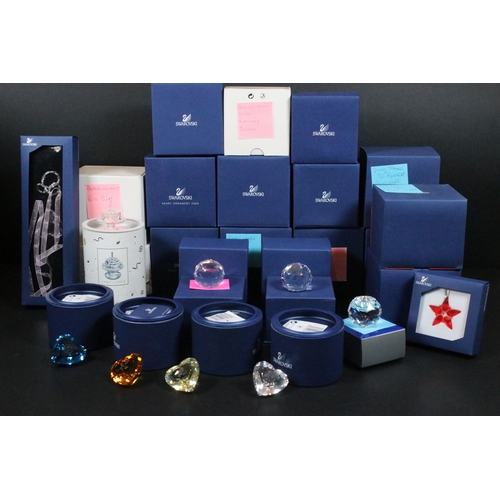 92 - Collection of Swarovski crystal, comprising primarily commemoratives and paperweights, including hea... 