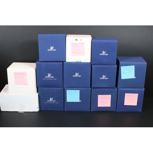 92 - Collection of Swarovski crystal, comprising primarily commemoratives and paperweights, including hea... 