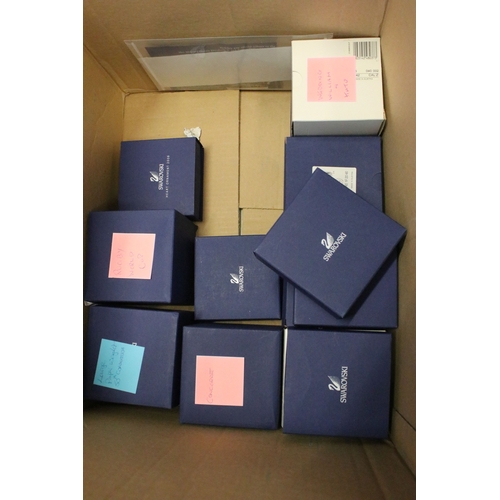 92 - Collection of Swarovski crystal, comprising primarily commemoratives and paperweights, including hea... 