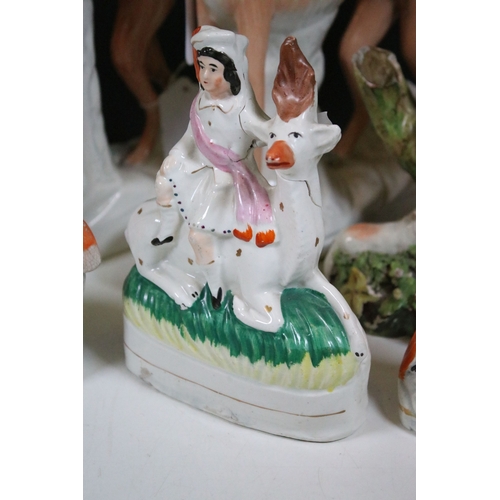 99 - Group of 19th century Staffordshire pottery, to include Scottish dancers, pair of Greyhound figures ... 