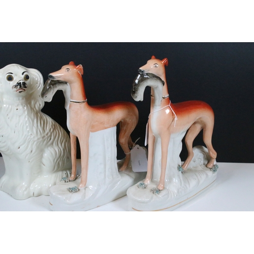 99 - Group of 19th century Staffordshire pottery, to include Scottish dancers, pair of Greyhound figures ... 