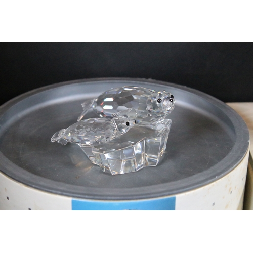 112 - Twenty-one boxed Swarovski crystal glass ornaments, to include a selection of 925 Sterling Silver go... 