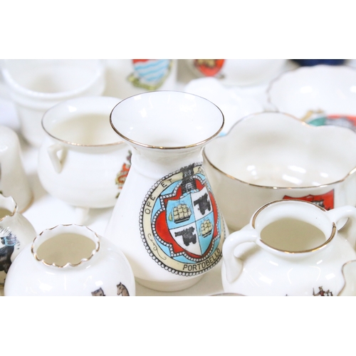 113 - Collection of Goss crested china, to include lighthouses, vases and pin dishes. Tallest measures 14.... 