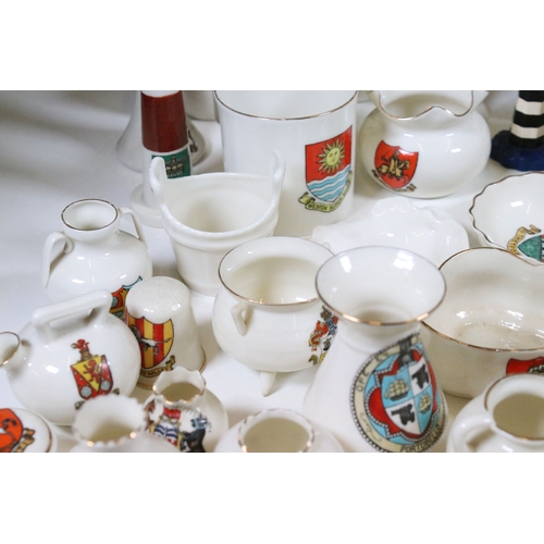 113 - Collection of Goss crested china, to include lighthouses, vases and pin dishes. Tallest measures 14.... 