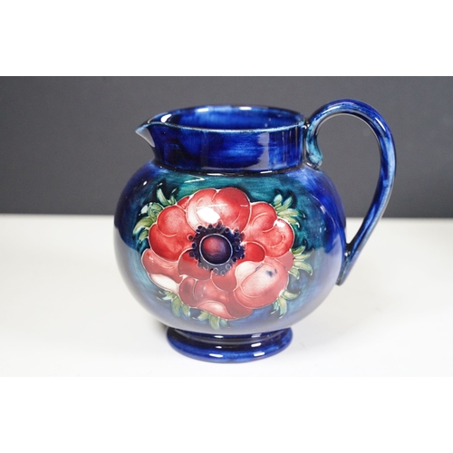 65 - Collection of Moorcroft ceramics to include 2 x Anemone jugs on blue ground (One William Moorcroft e... 