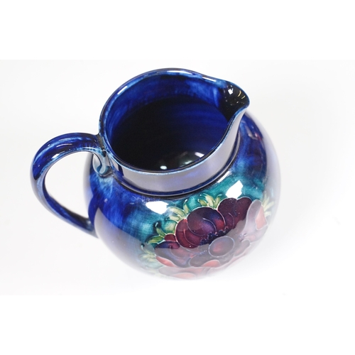 65 - Collection of Moorcroft ceramics to include 2 x Anemone jugs on blue ground (One William Moorcroft e... 