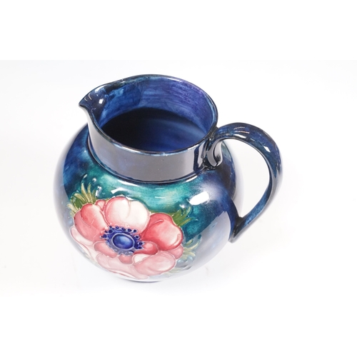 65 - Collection of Moorcroft ceramics to include 2 x Anemone jugs on blue ground (One William Moorcroft e... 