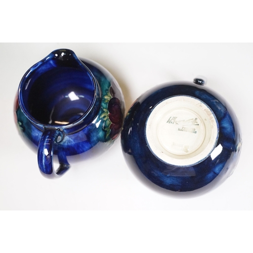 65 - Collection of Moorcroft ceramics to include 2 x Anemone jugs on blue ground (One William Moorcroft e... 