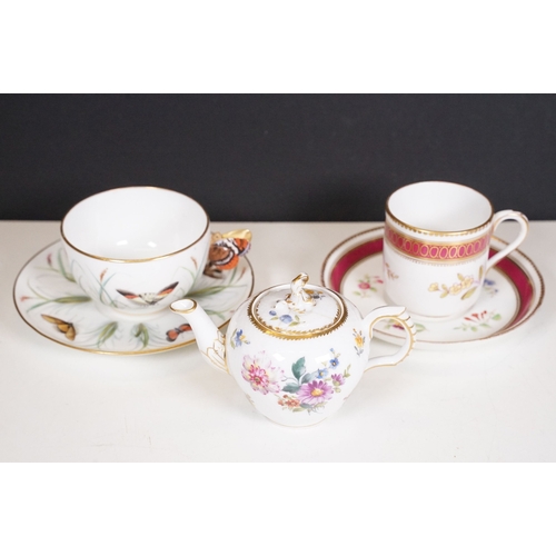 68 - Minton hand-painted cup and saucer decorated with butterflies, moths and foliage, the handle modelle... 