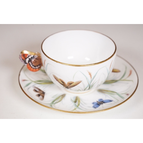 68 - Minton hand-painted cup and saucer decorated with butterflies, moths and foliage, the handle modelle... 