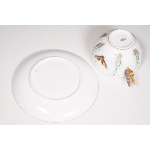 68 - Minton hand-painted cup and saucer decorated with butterflies, moths and foliage, the handle modelle... 