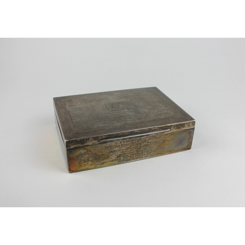 11 - A George V silver cigarette box with engraved decoration and central initials, presentation inscript... 