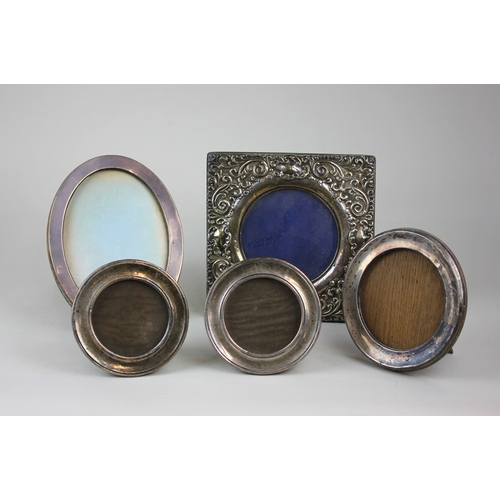 15 - Five early 20th century silver photograph frames including two small circular, 12cm, larger circular... 