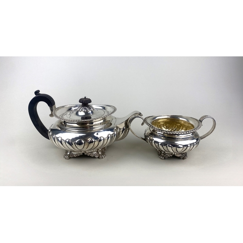 181 - An Edward VII silver teapot circular demi reeded form with raised gadrooned border, London 1906 and ... 