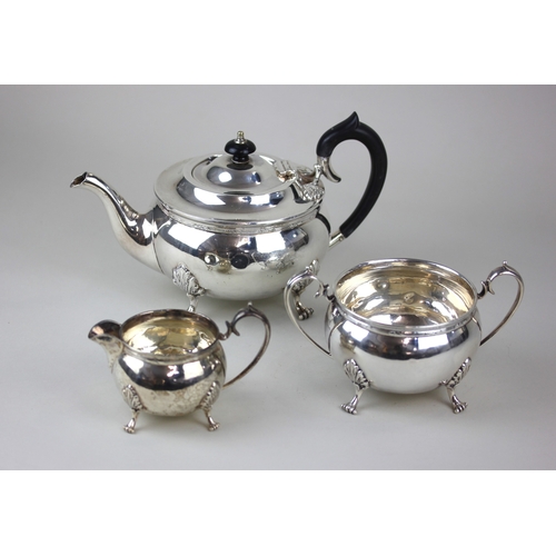 183 - A George V silver three-piece tea set comprising circular teapot, two handled sugar bowl and milk ju... 