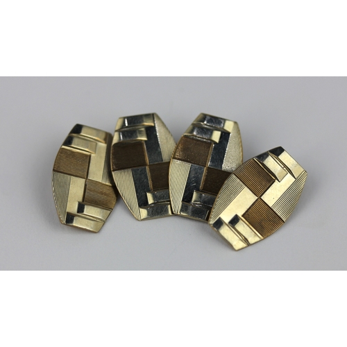 273 - A pair of two colour gold cufflinks the backs and fronts of barrel shaped form with Art Deco geometr... 