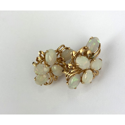 291 - A pair of gold and opal ear clips each mounted with five oval opals, with post and sprung clip fitti... 