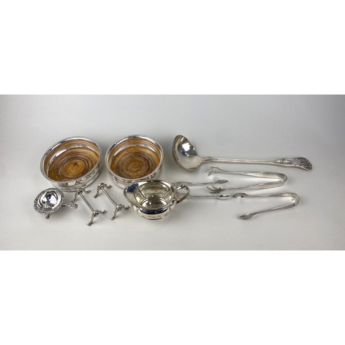 3 - A pair of silver plated wine coasters a soup ladle, cream jug, three pairs of sugar tongs, a tea str... 