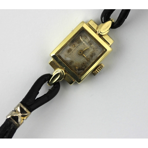 351 - A lady's gold shaped rectangular cased wristwatch, having an unsigned jewelled movement, the silvere... 