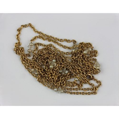 370 - A gold oval link long guard chain fitted with pairs of seed pearls and faceted glass divisions at in... 