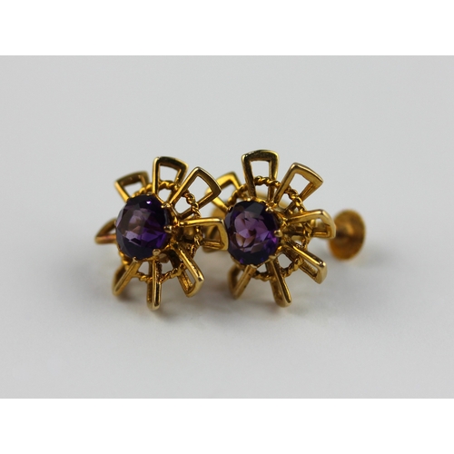 372 - A pair of 9ct gold and amethyst single stone earrings in a rope twist wire work and abstract design ... 