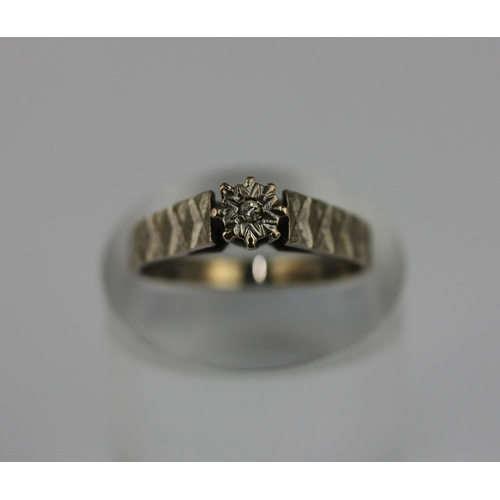 498 - An 18ct white gold and diamond single stone ring mounted with a circular cut diamond between decorat... 