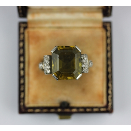 503 - A diamond and olive coloured gemstone ring in an Art Deco design, unmarked, ring size Q 1/2, 10g, in... 