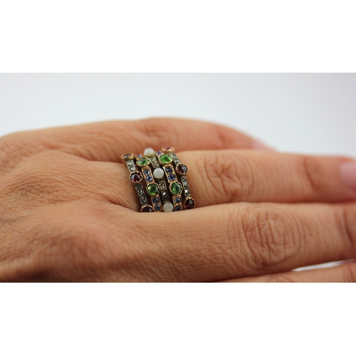 504 - A gold and silver set ruby demantoid garnet, sapphire, rose diamond and imitation pearl ring in a fi... 