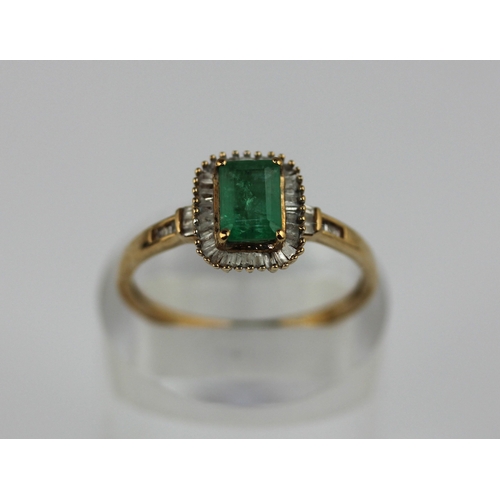 507 - A 9ct gold emerald and diamond rectangular cluster ring claw set with the rectangular cut emerald wi... 