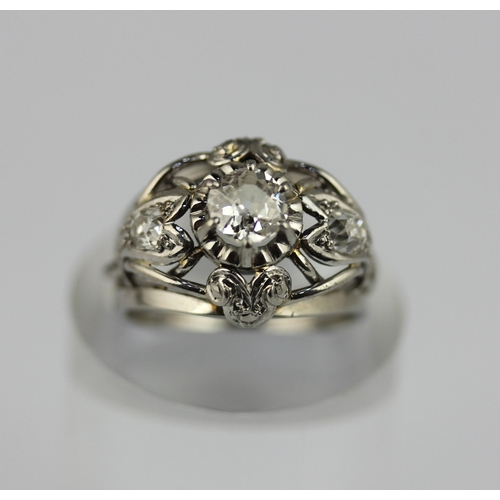 508 - A diamond ring claw set with the principal cushion shaped diamond at the centre between two smaller ... 