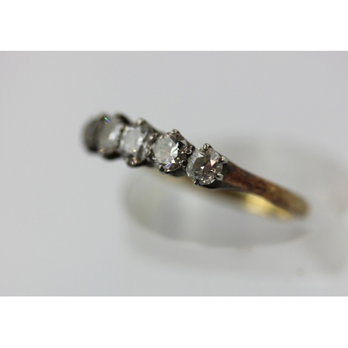 509 - A gold and diamond five stone ring, claw set with a row of graduated cushion shaped diamonds, detail... 