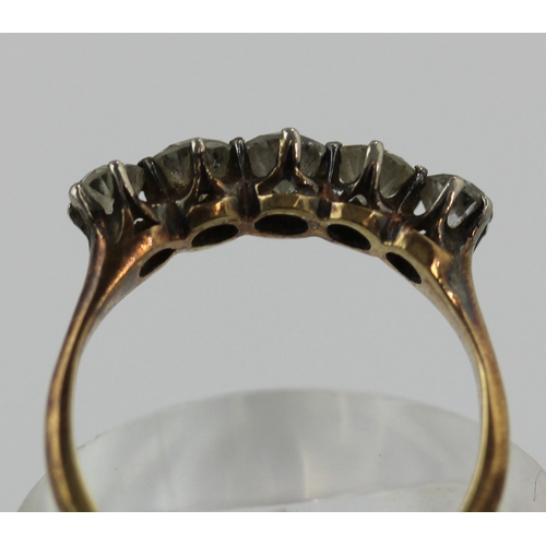 509 - A gold and diamond five stone ring, claw set with a row of graduated cushion shaped diamonds, detail... 