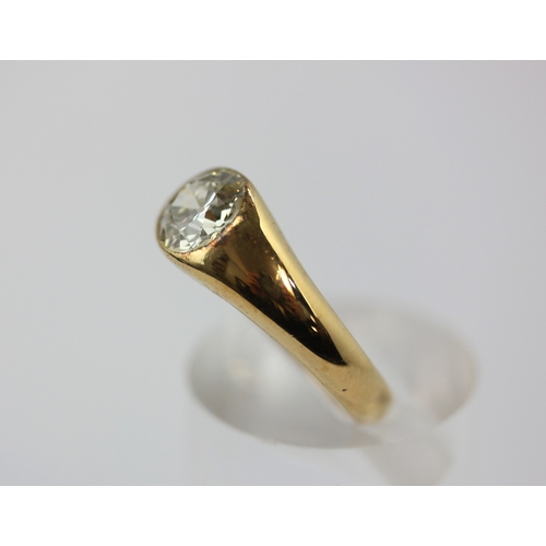 511 - A gold and diamond single stone ring, gypsy set with a cushion shaped diamond, detailed '18ct', ring... 